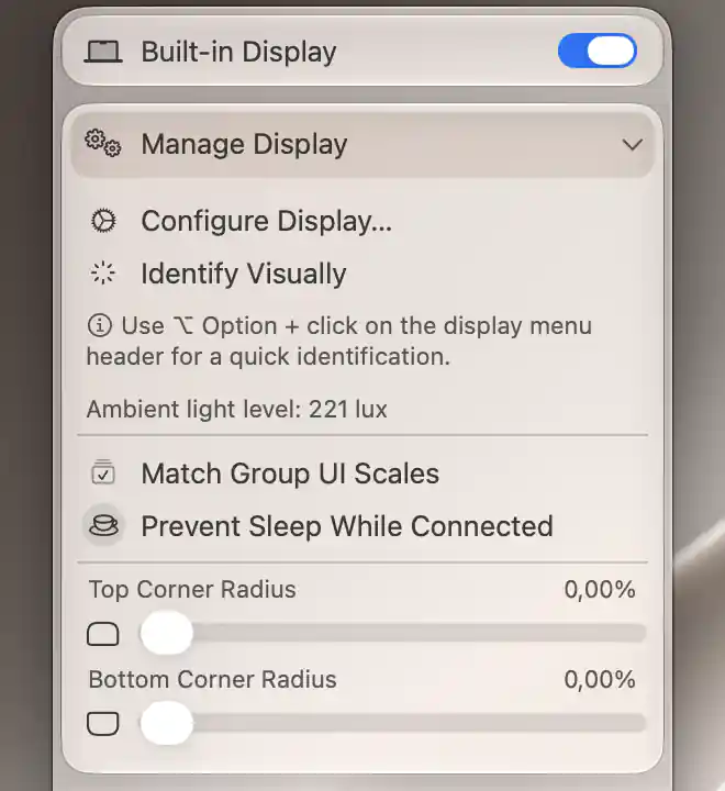 Built-in Manage Display with a live ambient-light sensor reading and both rounded-corner sliders