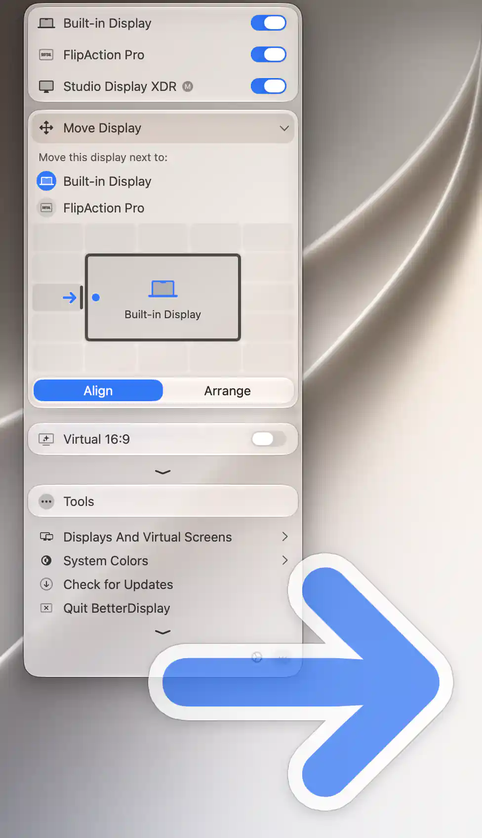 Studio Display XDR Align menu with a large arrow overlay on the display selected to move, using Built-in Display as reference